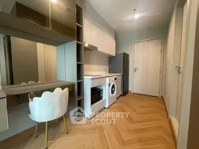 Modern apartment interior with washing machine and stylish furniture