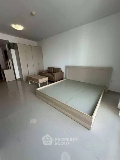 Spacious bedroom with modern furniture and ample natural light