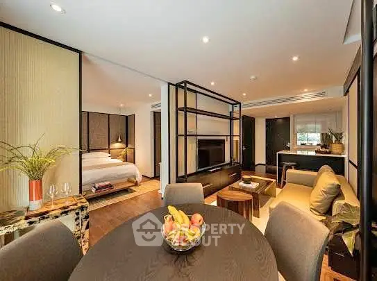 Luxurious open-plan living room with modern decor and cozy bedroom view