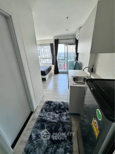 Modern studio apartment with open layout and balcony view