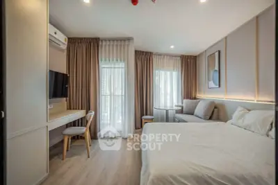 Modern bedroom with stylish decor, featuring a cozy bed, elegant curtains, and a functional workspace.