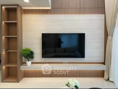 Modern living room with sleek TV setup and elegant wooden shelving