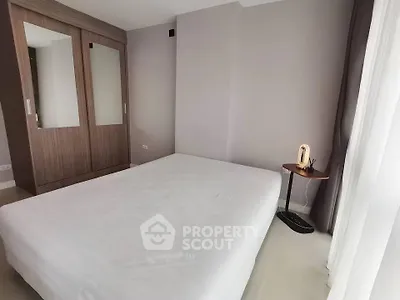 Spacious bedroom with modern wardrobe and natural light