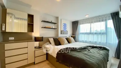 Modern bedroom with stylish decor and large window for natural light.