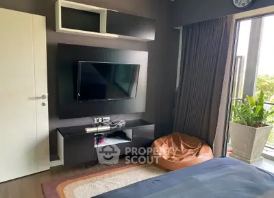 Modern living room with TV, bean bag, and balcony view