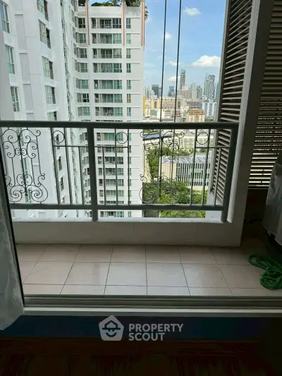 Charming balcony with cityscape view in modern high-rise apartment.