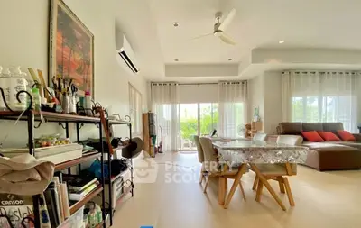 Spacious living room with modern decor and large windows for natural light.