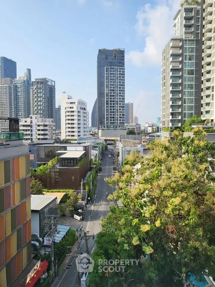 Stunning cityscape view showcasing modern high-rise buildings and lush greenery, perfect for urban living.
