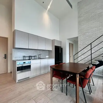 Modern kitchen with open layout and dining area in stylish apartment