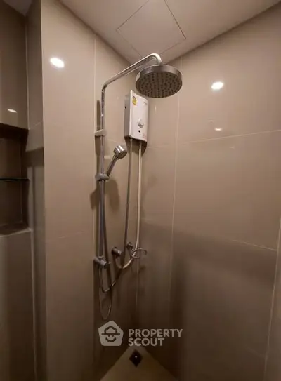 Modern bathroom shower with sleek fixtures and neutral tiles