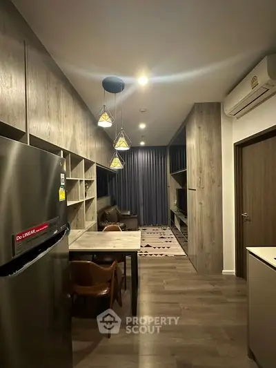 Modern living room with stylish decor and open layout, featuring elegant lighting and cozy seating area.