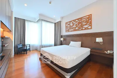 Spacious modern bedroom with wooden flooring and elegant decor