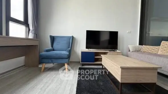 Modern living room with stylish furniture and large window for natural light.