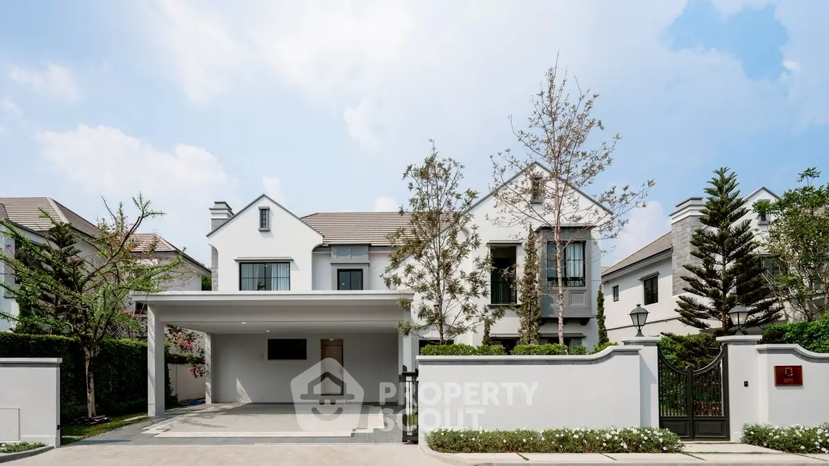 Elegant modern house exterior with spacious driveway and lush greenery, perfect for luxury living.