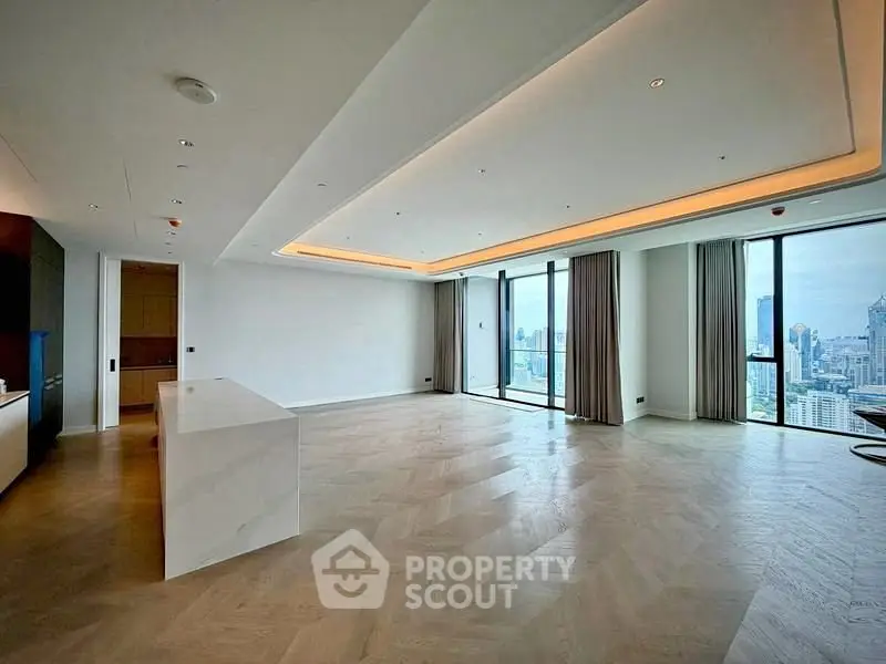 Spacious modern living room with panoramic city views and elegant wood flooring.