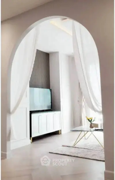 Elegant living room with modern decor and stylish archway