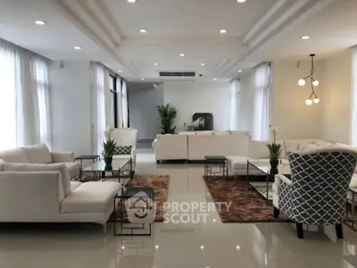 Spacious modern living room with elegant decor and ample natural light.