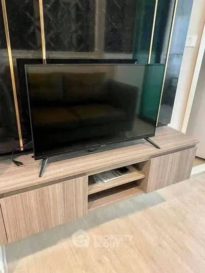 Modern living room with sleek TV stand and flat-screen television