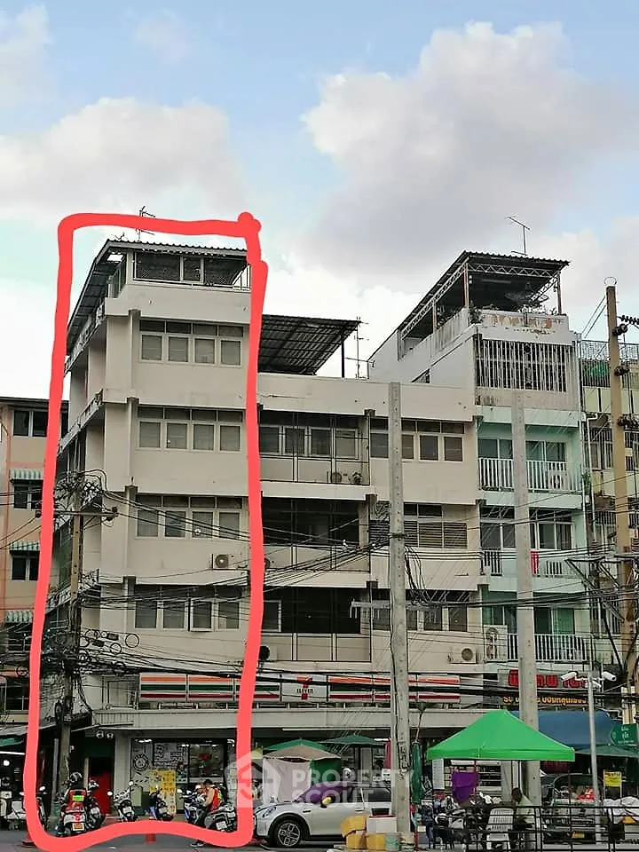 Urban commercial building with retail space on ground floor and residential units above.