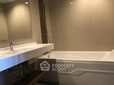 Modern bathroom with sleek bathtub and stylish sink design.