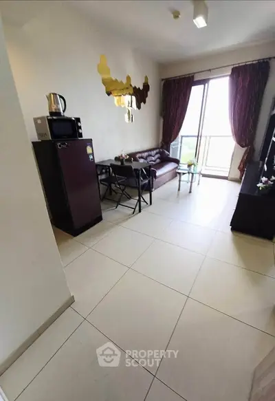 Cozy living room with modern decor and balcony access in a stylish apartment.