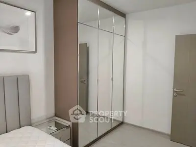 Modern bedroom with mirrored wardrobe and stylish decor