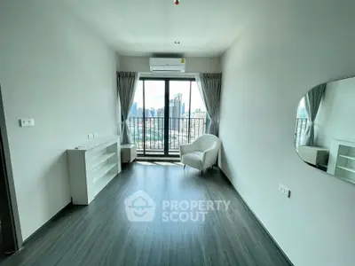 Modern living room with city view and balcony access in high-rise apartment