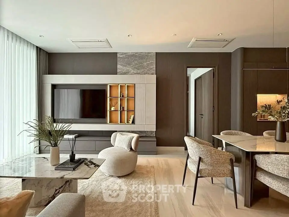 Luxurious modern living room with elegant decor and open dining area.