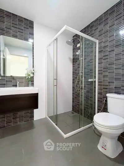 Modern bathroom with glass shower and sleek tile design