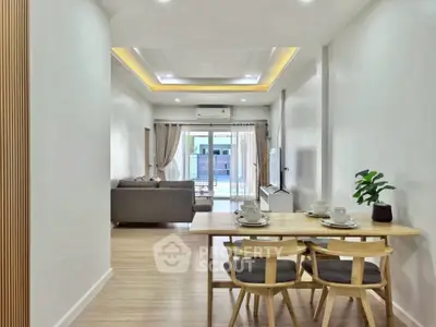 Spacious modern living room with dining area and balcony access