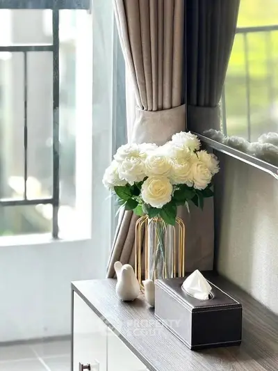 Elegant living room corner with flowers and modern decor