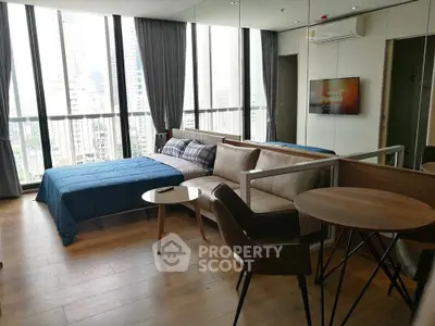 Modern studio apartment with city view, featuring stylish furniture and floor-to-ceiling windows.