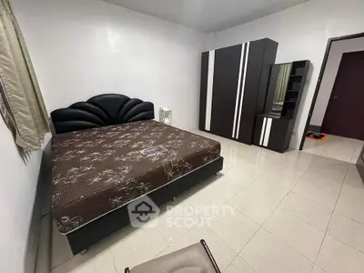 Spacious bedroom with modern furniture and ample storage space