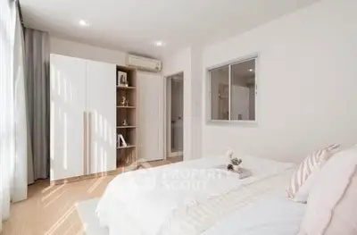 Bright and airy bedroom with modern decor and ample natural light.