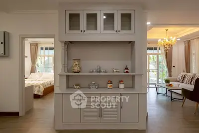 Elegant living room with stylish decor and cozy bedroom view, perfect for modern living.