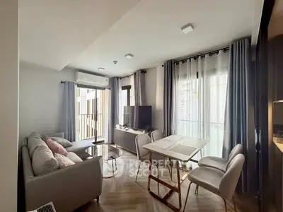 Modern living room with cozy seating and natural light in a stylish apartment.
