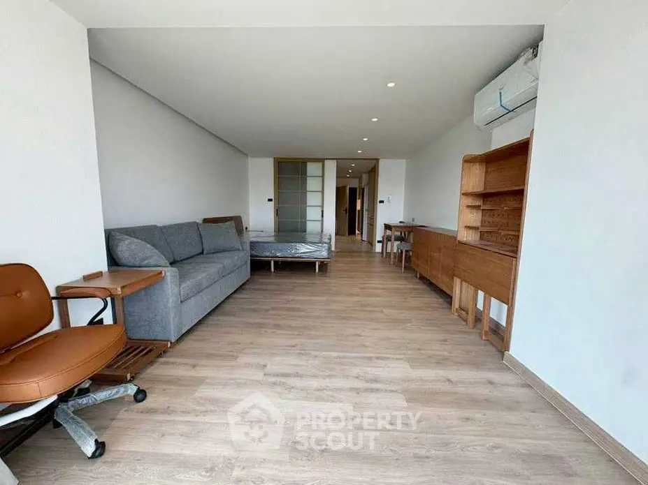 Spacious modern living room with wooden flooring and stylish furniture