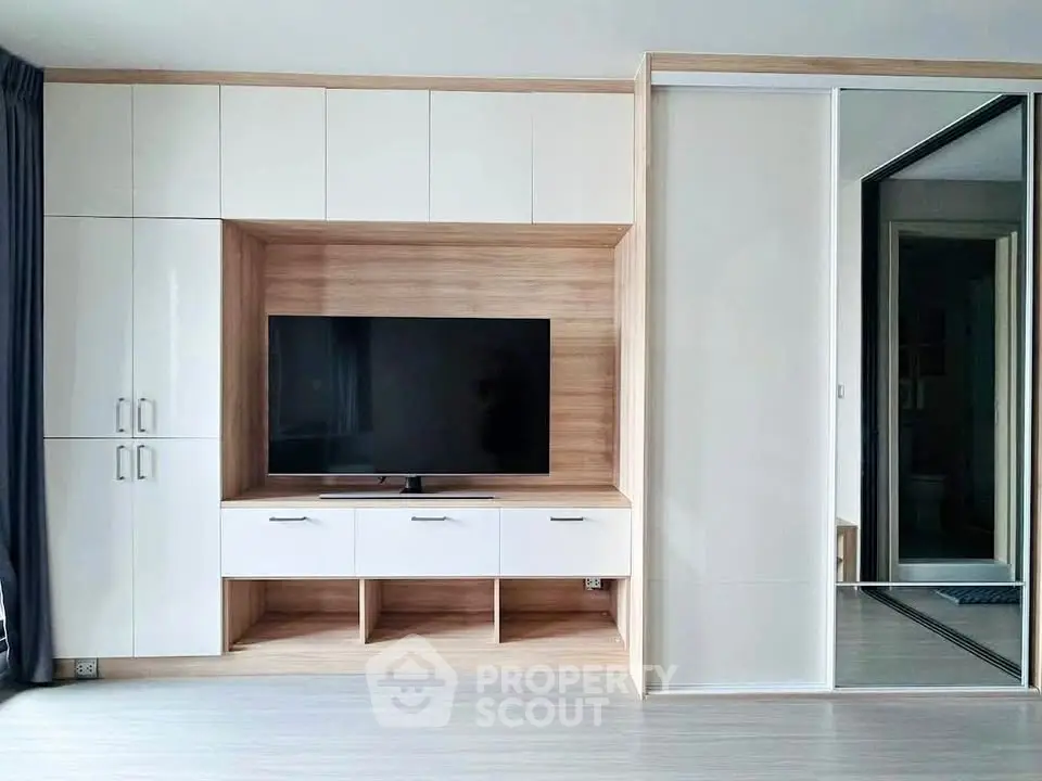 Modern living room with sleek built-in entertainment center and large TV