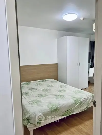 Cozy bedroom with modern decor and ample storage in a stylish apartment.