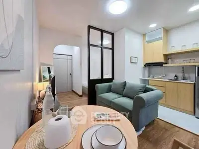 Charming open-layout living room with cozy kitchen and modern decor.