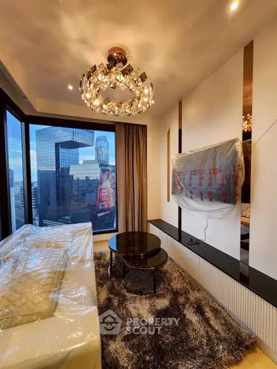 Luxurious living room with stunning city view, elegant chandelier, and modern decor in high-rise apartment.