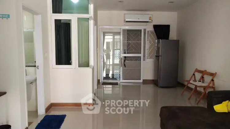 Spacious modern living room with sleek flooring and natural light