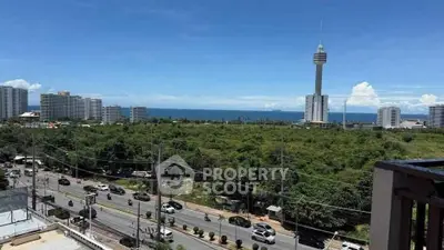 Stunning cityscape view with ocean backdrop from high-rise balcony