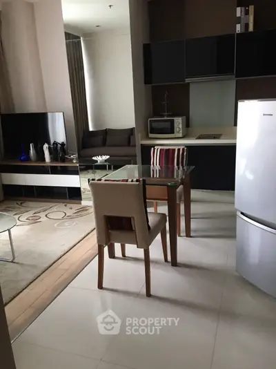 Modern open-plan living room and kitchen with stylish furniture and appliances