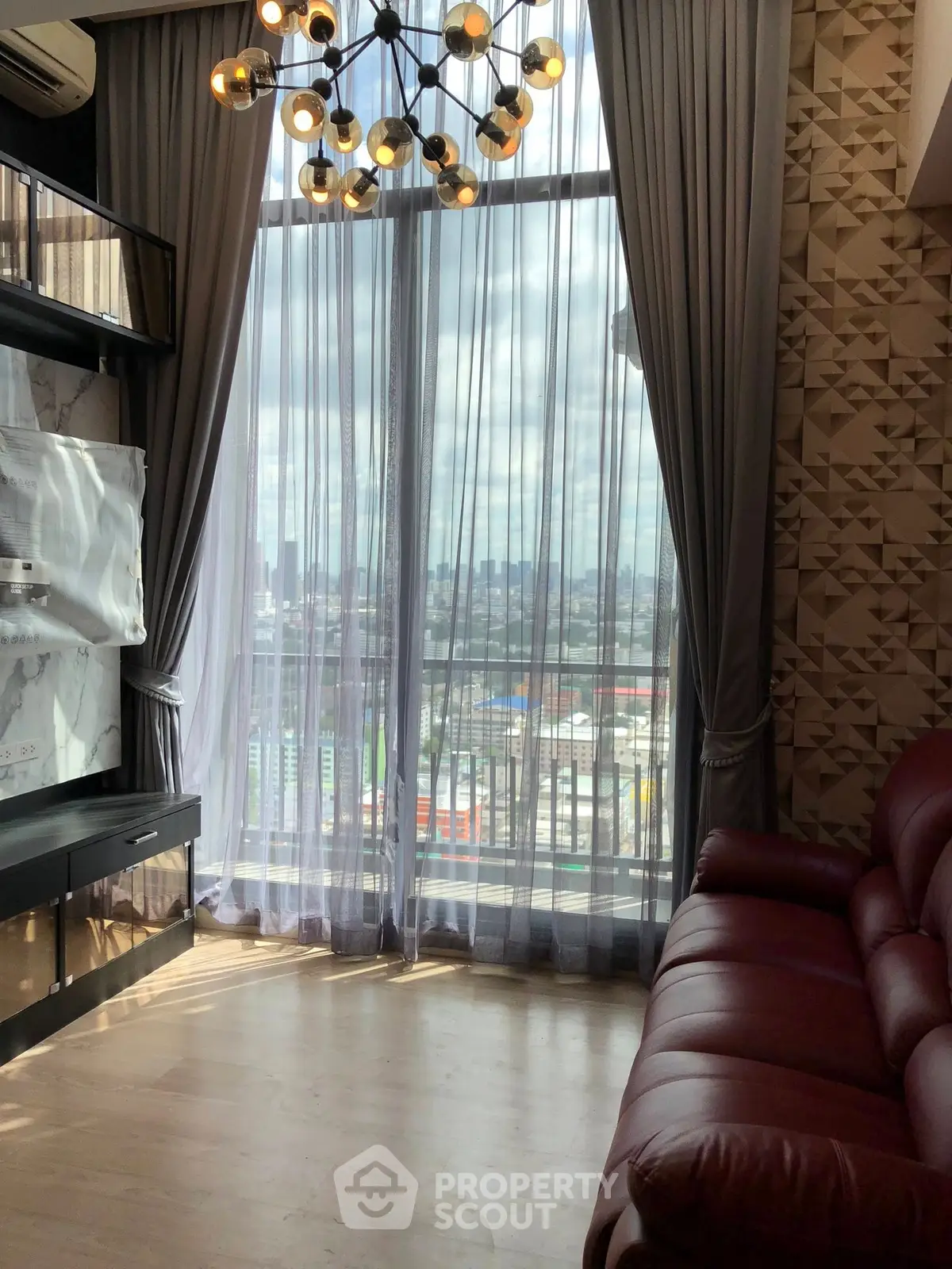 Luxurious living room with floor-to-ceiling windows and stunning city view.