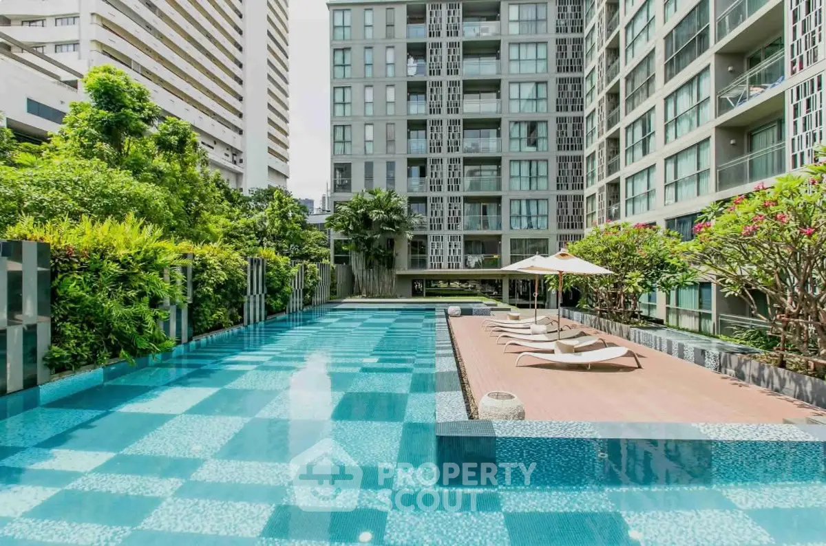 Luxurious condominium with stunning pool and lush greenery, perfect for relaxation and modern living.