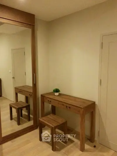 Cozy study nook with wooden desk and mirror in modern apartment.