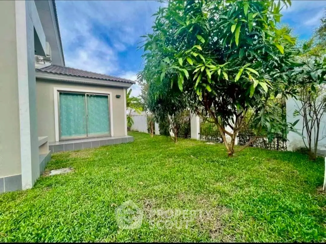 Charming garden view of a modern home with lush greenery and serene outdoor space.