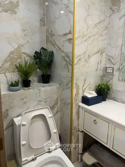 Luxurious marble bathroom with elegant gold accents and modern decor