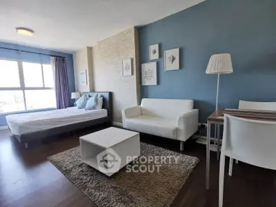 Modern studio apartment with stylish decor and large window view
